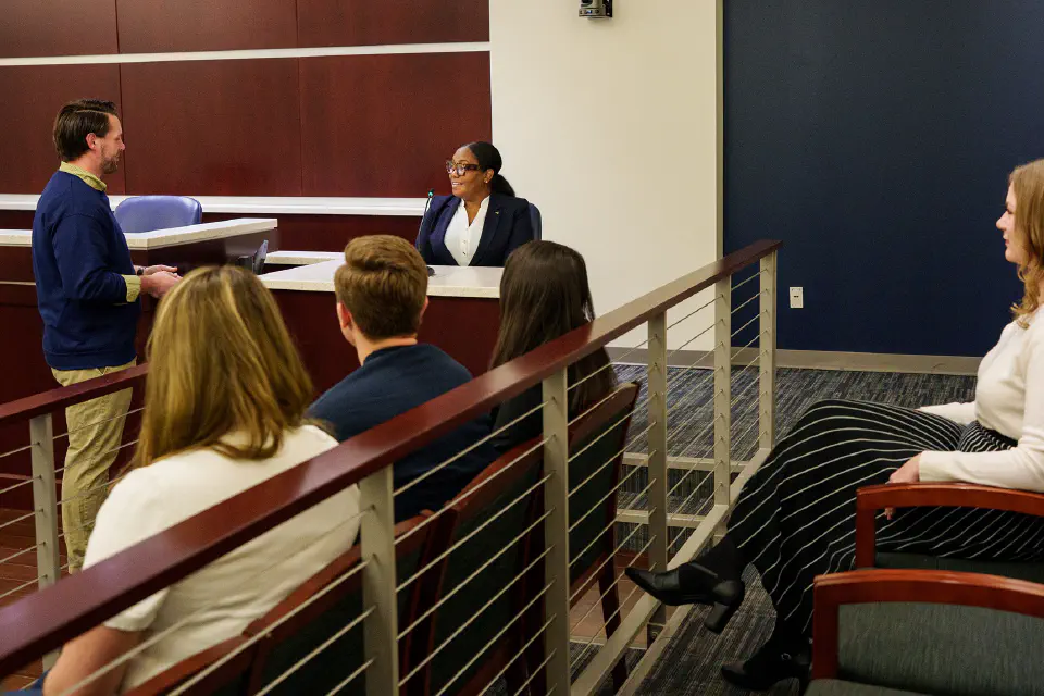 WVU Law students sit in a mock courtroom practicing open arguments.